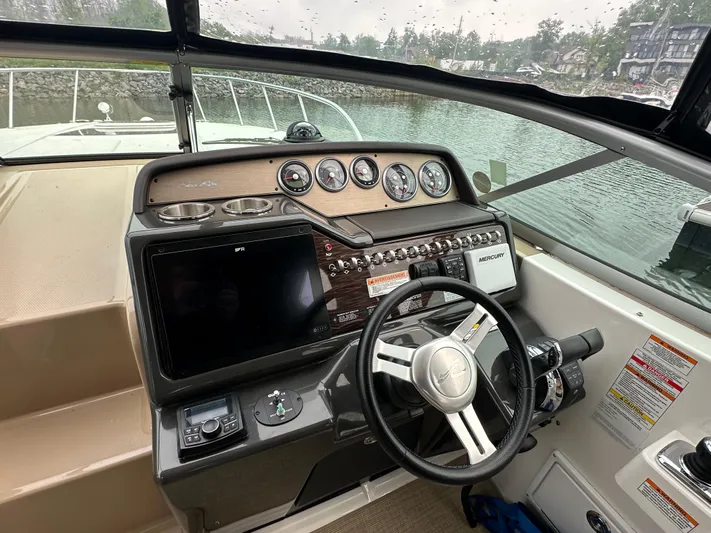 Yacht Photos Pics 2017 Sea Ray Sundancer 310 helm with gauges, steering wheel, and navigation controls.