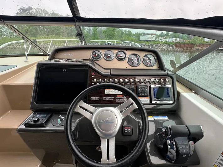  Yacht Photos Pics 2017 Sea Ray Sundancer 310 helm with steering wheel, gauges, and navigation controls.