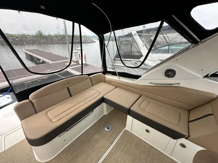  Yacht Photos Pics Luxurious interior of 2017 Sea Ray Sundancer 310 yacht with beige seating and panoramic windows.