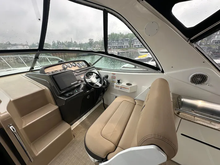  Yacht Photos Pics 2017 Sea Ray Sundancer 310 helm with modern controls and beige seating, dockside view.