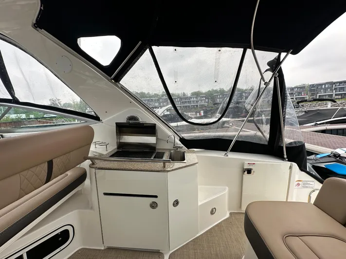  Yacht Photos Pics Interior of 2017 Sea Ray Sundancer 310 with seating and kitchenette.