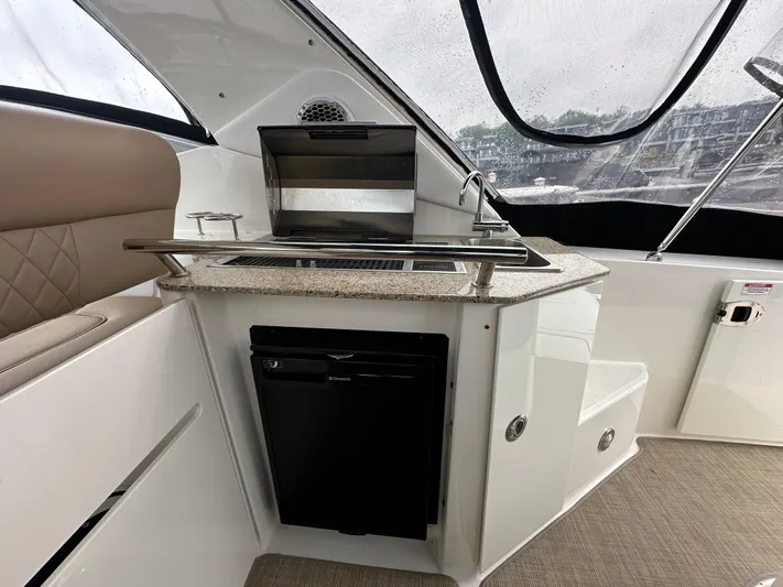  Yacht Photos Pics Interior of 2017 Sea Ray Sundancer 310 yacht with kitchenette and seating area.