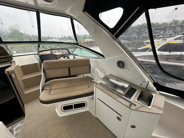  Yacht Photos Pics 2017 Sea Ray Sundancer 310 interior with helm, seating, and kitchenette.