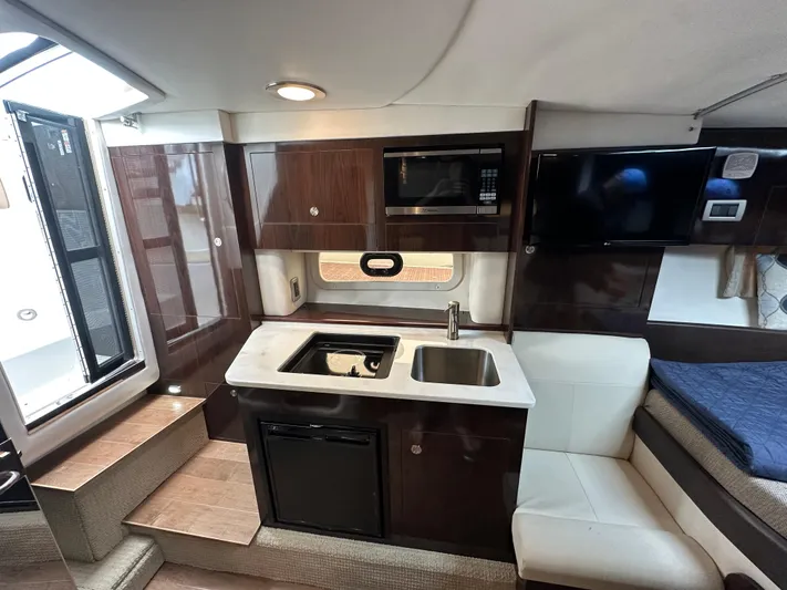  Yacht Photos Pics Interior of 2017 Sea Ray Sundancer 310 yacht with kitchenette and seating area.