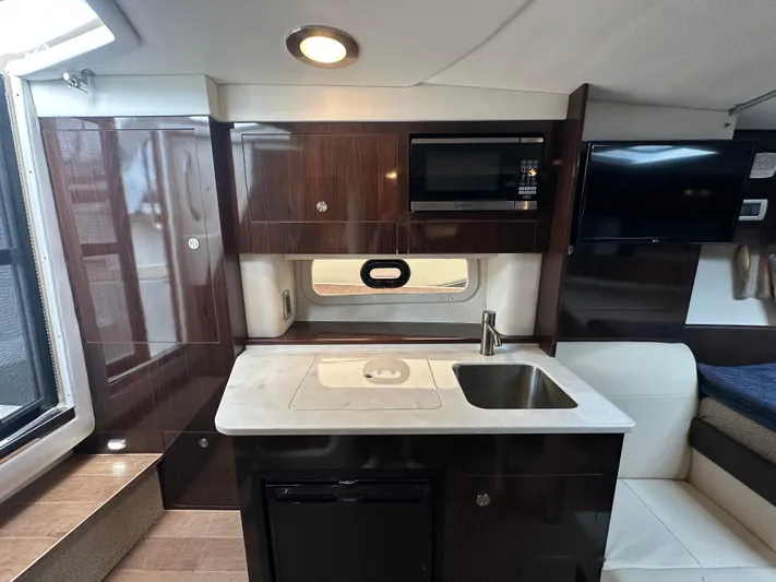  Yacht Photos Pics 2017 Sea Ray Sundancer 310 interior with kitchenette, sink, microwave, and seating area.