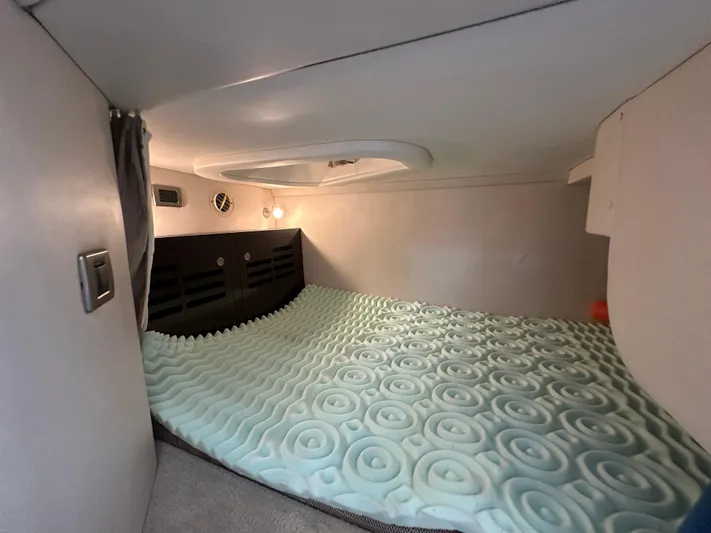  Yacht Photos Pics 2017 Sea Ray Sundancer 310 cabin interior with foam mattress and ambient lighting.