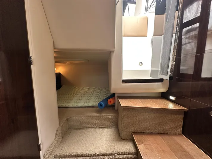  Yacht Photos Pics 2017 Sea Ray Sundancer 310 cabin interior with cozy sleeping area and wooden steps.