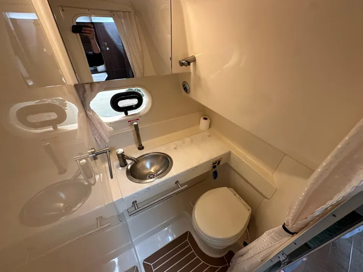  Yacht Photos Pics 2017 Sea Ray Sundancer 310 bathroom with sink, toilet, and porthole window.