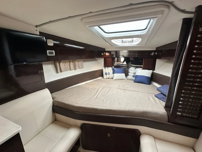  Yacht Photos Pics Luxurious interior of 2017 Sea Ray Sundancer 310 yacht with cozy bedding and modern amenities.