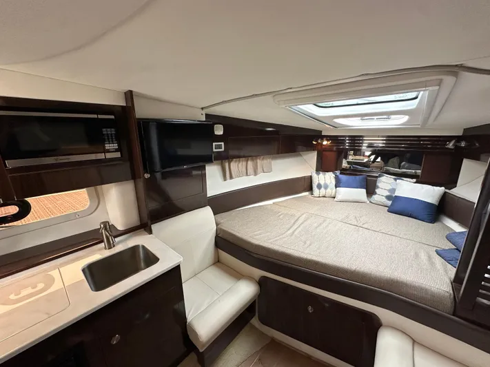  Yacht Photos Pics 2017 Sea Ray Sundancer 310 cabin interior with bed, seating, and kitchenette.