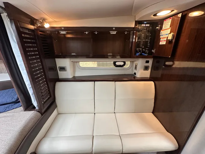  Yacht Photos Pics Interior of 2017 Sea Ray Sundancer 310 with beige seating and dark wood cabinetry.