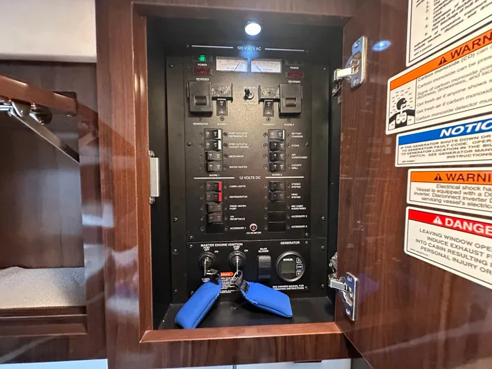  Yacht Photos Pics Electrical control panel inside 2017 Sea Ray Sundancer 310 boat, featuring switches and warning labels.