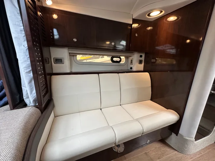  Yacht Photos Pics Luxurious interior of 2017 Sea Ray Sundancer 310 with cream leather seating and wooden cabinetry.