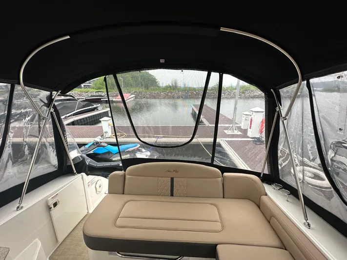 Yacht Photos Pics 2017 Sea Ray Sundancer 310 interior with dock view, featuring beige seating and canopy.