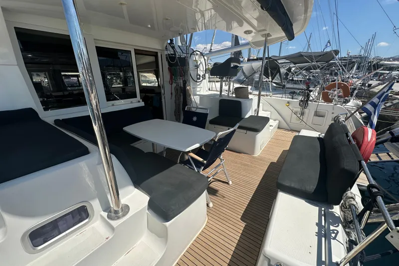 Yacht Photos Pics Spacious deck of 2018 Lagoon 40 catamaran with seating and table, docked at marina.