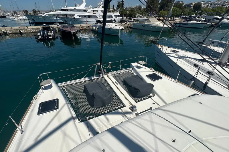  Yacht Photos Pics 2018 Lagoon 40 catamaran docked in a marina with other boats.