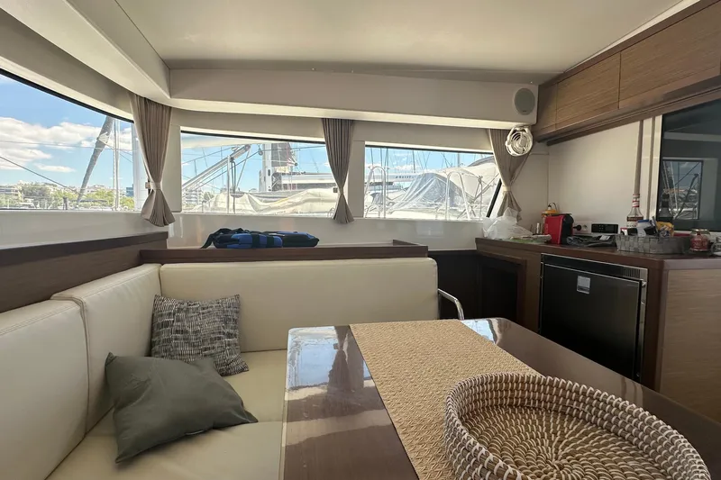  Yacht Photos Pics Interior of 2018 Lagoon 40 catamaran with modern seating and large windows.