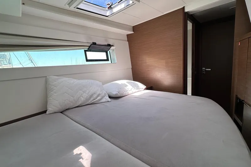  Yacht Photos Pics Cozy bedroom interior of 2018 Lagoon 40 catamaran with natural light and modern design.