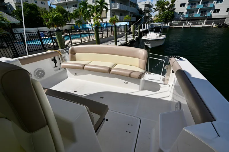 Amejaie II Yacht Photos Pics 2000 Tiara Yachts 3500 Express boat interior with seating, docked near waterfront buildings.