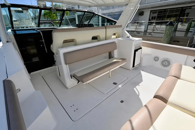 Amejaie II Yacht Photos Pics 2000 Tiara Yachts 3500 Express interior with seating and mini fridge.