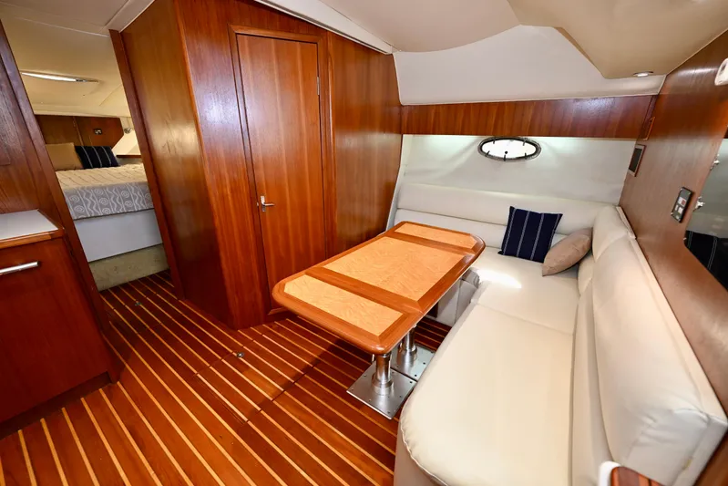 Amejaie II Yacht Photos Pics Interior of 2000 Tiara Yachts 3500 Express with wood paneling and cozy seating area.