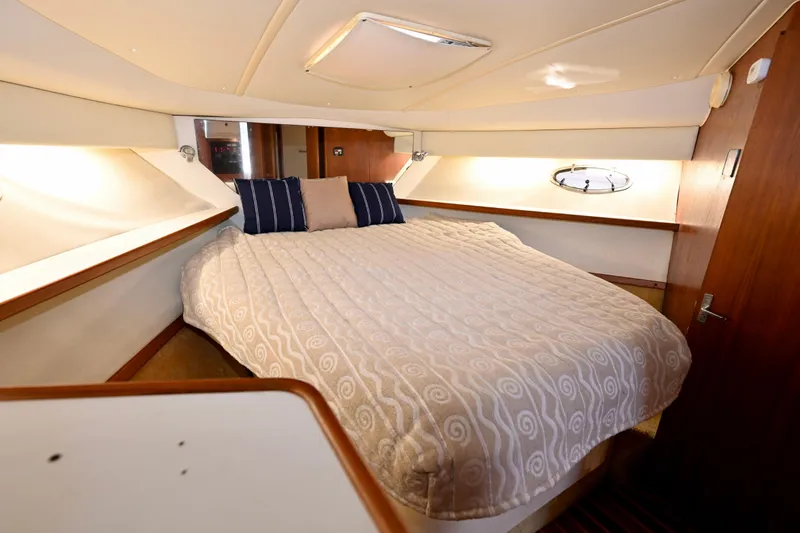 Amejaie II Yacht Photos Pics Luxurious cabin interior of 2000 Tiara Yachts 3500 Express with cozy bedding.
