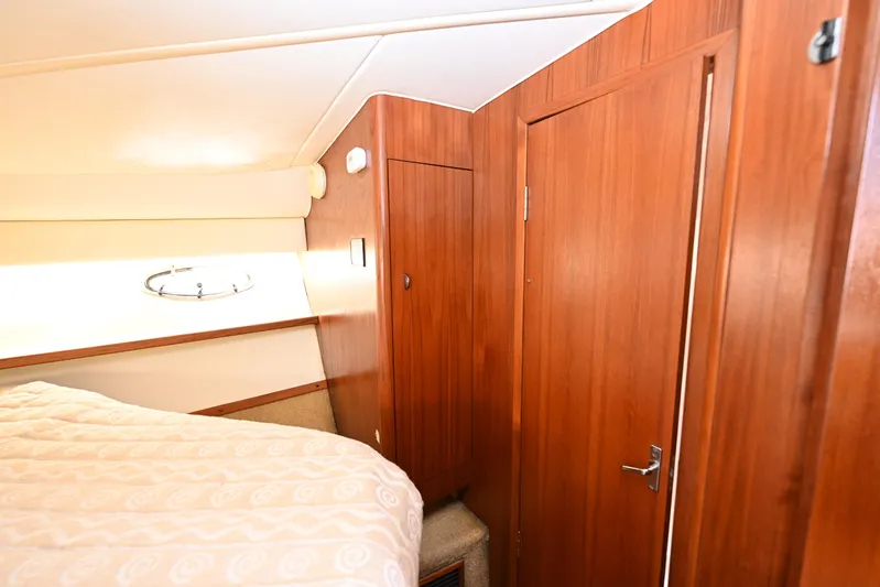 Amejaie II Yacht Photos Pics Interior cabin of 2000 Tiara Yachts 3500 Express with wood paneling and bed.