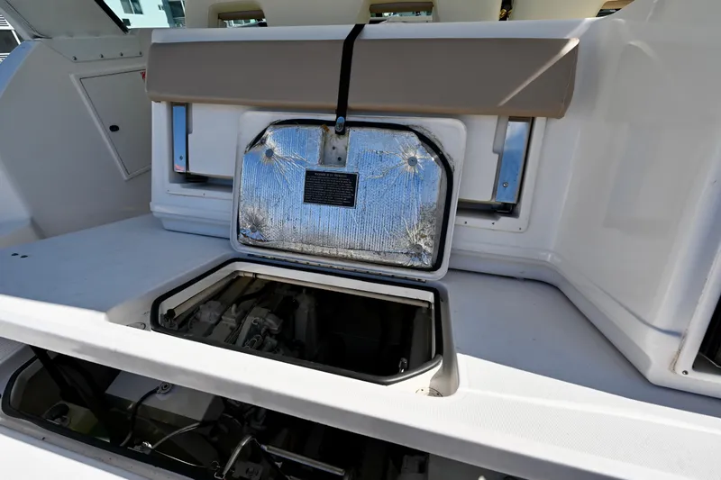 Amejaie II Yacht Photos Pics Open engine compartment of 2000 Tiara Yachts 3500 Express boat, showcasing interior details.