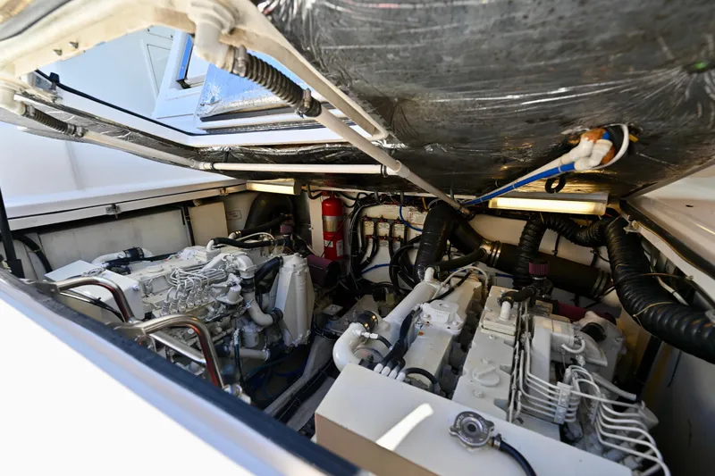 Amejaie II Yacht Photos Pics Engine room of 2000 Tiara Yachts 3500 Express, showcasing dual engines and fire extinguisher.