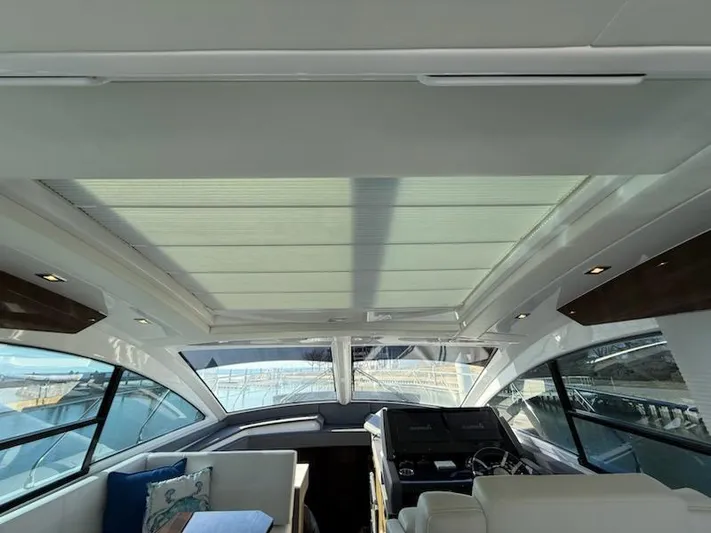 Emilia Yacht Photos Pics Interior view of 2022 Cruisers Yachts 54 Cantius with modern helm and seating area.