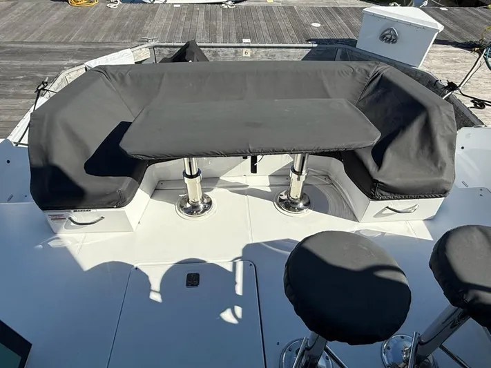 Emilia Yacht Photos Pics 2022 Cruisers Yachts 54 Cantius deck with covered seating and table.