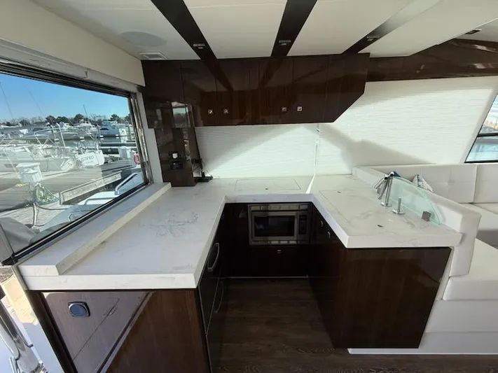 Emilia Yacht Photos Pics Luxurious kitchen interior of 2022 Cruisers Yachts 54 Cantius with modern appliances and sleek design.