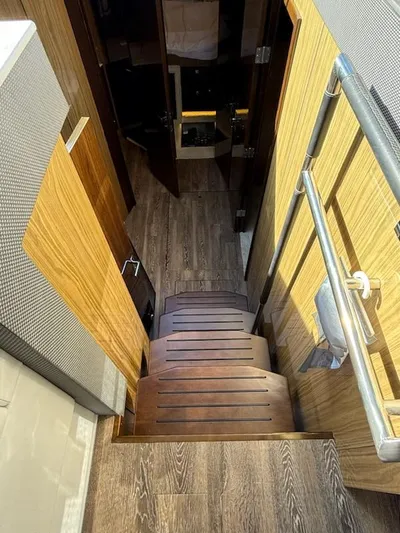 Emilia Yacht Photos Pics Interior stairs of 2022 Cruisers Yachts 54 Cantius with wooden flooring.
