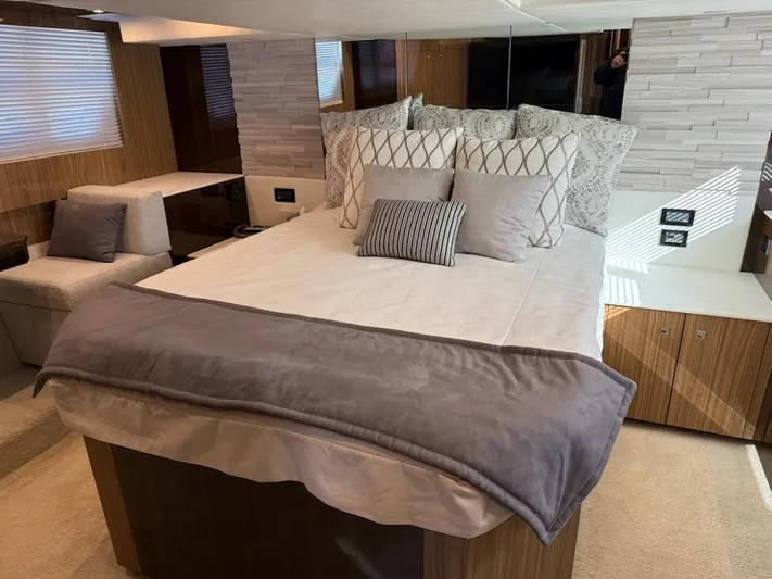 Emilia Yacht Photos Pics Luxurious bedroom interior of 2022 Cruisers Yachts 54 Cantius with modern decor and cozy bedding.