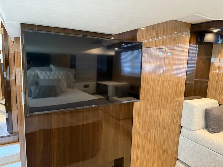 Emilia Yacht Photos Pics Luxurious interior of 2022 Cruisers Yachts 54 Cantius with sleek TV and modern furnishings.