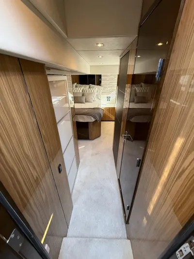 Emilia Yacht Photos Pics Luxurious interior of 2022 Cruisers Yachts 54 Cantius with modern wood finishes and cozy bedroom.