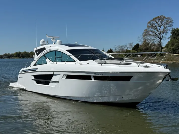 Emilia Yacht Photos Pics 2022 Cruisers Yachts 54 Cantius on calm water, showcasing sleek design and modern features.