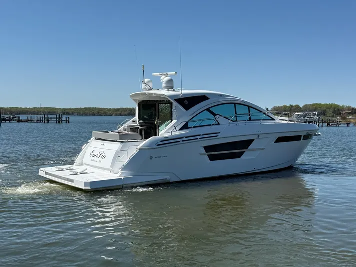 Emilia Yacht Photos Pics 2022 Cruisers Yachts 54 Cantius on calm water, showcasing sleek design and luxury features.