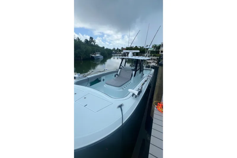  Yacht Photos Pics 2025 Front Runner 37 Catamaran docked by a serene waterfront.