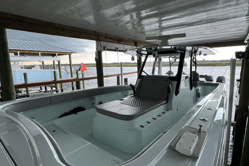  Yacht Photos Pics 2025 Front Runner 37 Catamaran docked under a covered pier, showcasing sleek design.