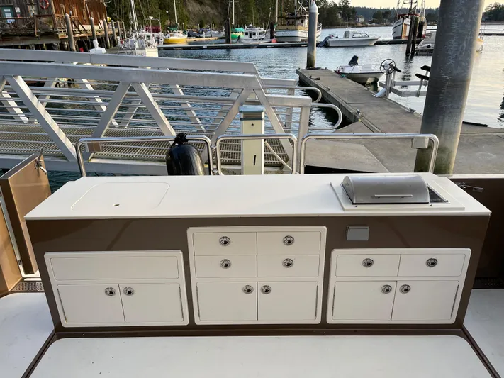  Yacht Photos Pics Outdoor kitchen on a 2012 Coastal Craft 56 yacht, docked at a marina.