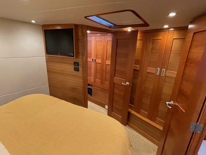  Yacht Photos Pics Luxurious cabin interior of 2012 Coastal Craft 56 yacht with wood paneling and TV.