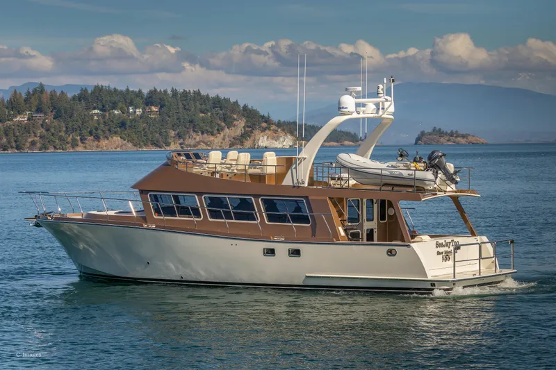  Yacht Photos Pics 2012 Coastal Craft 56 yacht cruising on scenic waters with islands in the background.