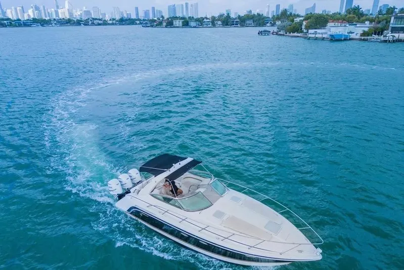  Yacht Photos Pics 2003 Formula 34 Performance Cruiser navigating blue waters near city skyline.