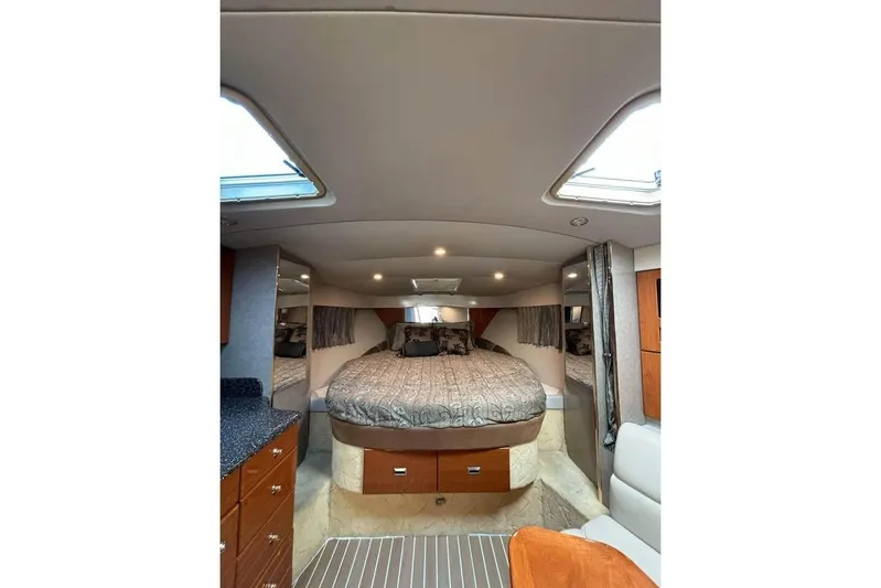  Yacht Photos Pics Interior of 2003 Formula 34 Performance Cruiser with cozy bed and elegant wood cabinetry.