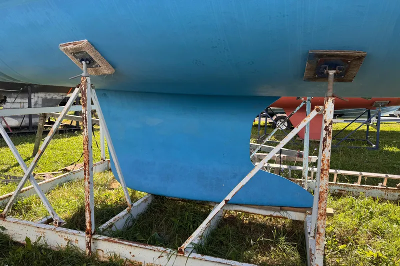 Still In The Moment Yacht Photos Pics 2007 Beneteau 423 sailboat keel on metal stands, grass background.