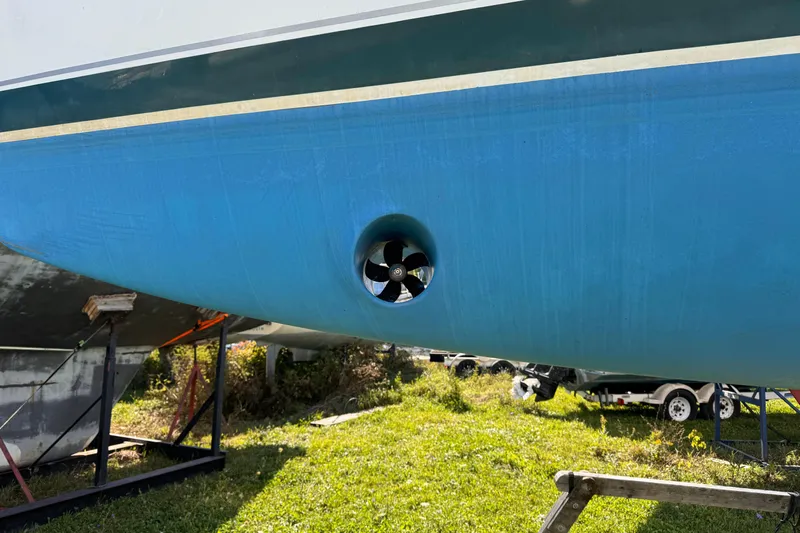 Still In The Moment Yacht Photos Pics Bow thruster on a 2007 Beneteau 423 sailboat hull, displayed on a stand.