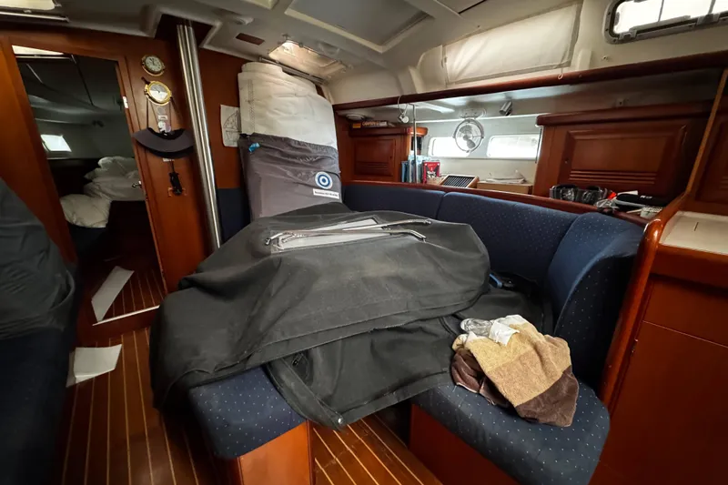 Still In The Moment Yacht Photos Pics Interior of 2007 Beneteau 423 sailboat with blue seating and wooden accents.