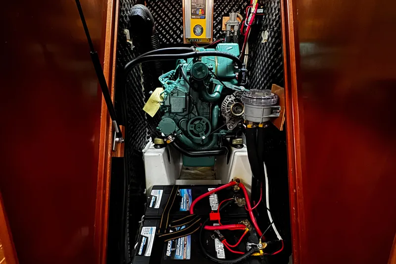 Still In The Moment Yacht Photos Pics Engine compartment of a 2007 Beneteau 423 sailboat, featuring batteries and wiring.