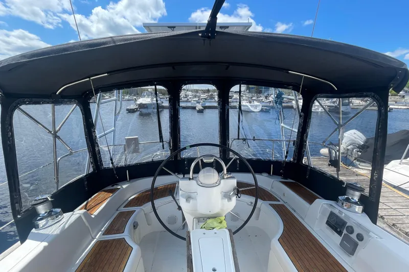 Still In The Moment Yacht Photos Pics Cockpit view of 2007 Beneteau 423 sailboat with marina background.